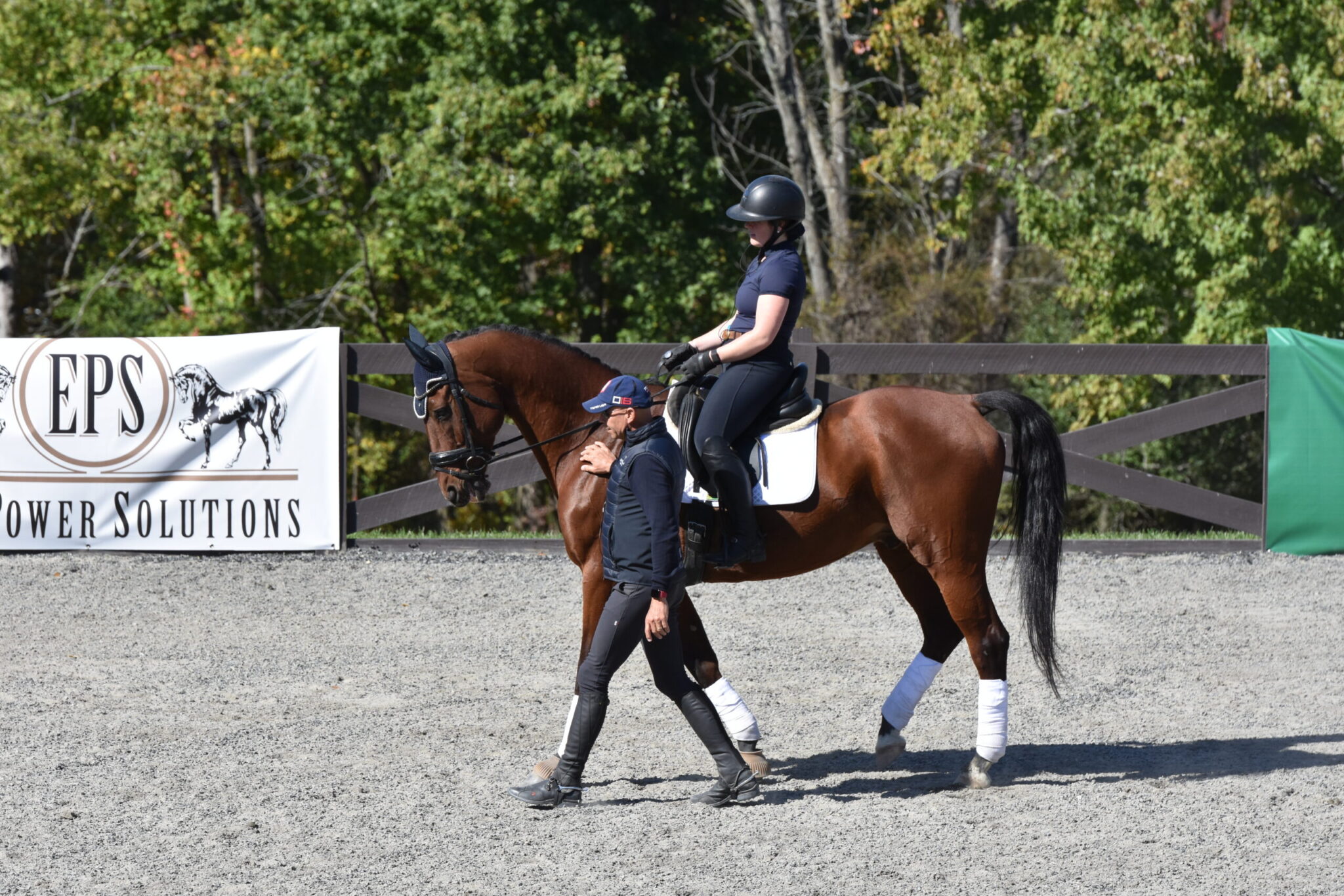 Steffen Peters walks perfectly in stride next to the horse.
